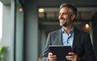 © Logan - Happy elegant middle aged professional business man financial executive manager using digital tablet. Smiling confident mature businessman holding tab computer technology looking away at copy space.