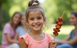 © Joseph - Joyful Little Girl with Grilled Skewers Portrait of Happy Child at a Summer Garden Party. High quality