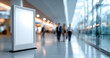 © perfectlab - Blank vertical advertising billboard in modern bright airport terminal with blurred business people walking in background