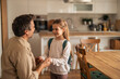 © Jelena - Father Encouraging Daughter With Backpack in a Bright Kitchen Setting