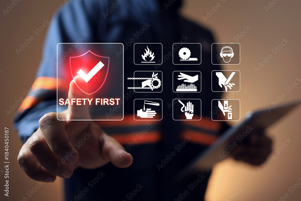 Safety first concept with safety staff pointing on virtual interface to ...