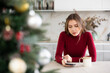 © JackF - Young upset woman waiting for message on her mobile phone in kitchen at home
