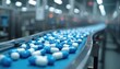 © Pete - Blue and white capsules move along automated conveyor belt in pharma factory. Medicine production line processes drugs. Automated facility makes pills for healthcare market.