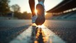 © Viktor - Close view of person feet running on track at stadium during sunset. Athlete shoe steps forward, motion blur effect. Athletic training and fitness concept.