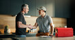 © Wess/peopleimages.com - Men, plumber and client with handshake in kitchen for solution, maintenance and leak repair. Homeowner, handyman and shaking hands in home for help, job completion and thank you for call out service