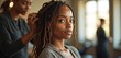 © Vadym - Black woman with dreadlocks gets hair styled in salon. Hairstylist works on client locks. Beauty care and hair fashion in studio. Female clients pamper themselves.
