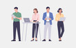© fatimatz - Diverse professionals actively engage with their digital devices and collaborate in a contemporary business setting
