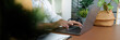© Natee Meepian - Remote Work: Professional using laptop for digital tasks in a modern workspace