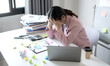 © Orathai - Working Asian women feel stressed, tired from work, migraine headaches from hard work while working at the office
