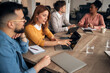 © Jelena - Group Collaboration in Modern Office - Professionals Discuss Ideas and Plans