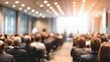 © Gulnaz - A large group of people are sitting in a room, some of them wearing suits