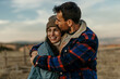 © La Famiglia - Loving couple embracing outdoors enjoying happy moment