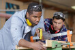© auremar - two young carpenters working in shop