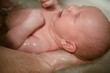 © Sk Elena - A newborn baby enjoys a gentle bath, supported by a caring parent hand. The moment captures the tenderness, trust, and importance of bathing in early childcare.