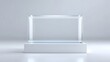 © pkproject - A clear rectangular glass showcase with a subtle blue tint sits atop a simple white rectangular stand against a soft neutral gray background ideal for product presentation or exhibit