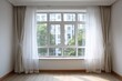 © free - Light streams through a large window with beige and sheer curtains.