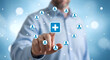 © Pixel Studio - Businessman interacts with a digital network connecting multiple user profiles to a central medical health services icon on a blue background symbolizing healthcare connectivity and patient care manag