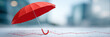 © javu - Stable financial protection concept with red umbrella shielding graph and subtle confident tone