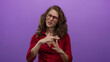 © Krakenimages.com - Woman gestures time out on purple background wearing glasses and red shirt, expressing emotion in a studio setting.