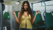 © Krakenimages.com - Woman with hands in meditation mudra and bare midriff standing in bus wearing yellow crochet top; mindfulness calm.