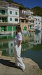 © Krakenimages.com - Woman enjoying a sunny day at cala figuera port in mallorca surrounded by boats and traditional mediterranean architecture.