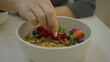 © Krakenimages.com - Woman enjoying healthy salad in modern luxury restaurant with fresh fruits and granola on table indoors, highlighting nutrition and lifestyle.