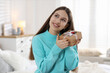© New Africa - Teenage girl with decorated gift box at home. Christmas atmosphere