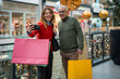© Jelena - Happy couple taking selfie enjoying holiday shopping