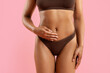 © Anastasiya - Closeup of toned body of young black woman in brown underwear on pink background. Toned abs, smooth skin and minimalist style ideal for wellness, fitness, lingerie and beauty imagery