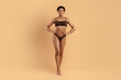 © Anastasiya - Full length portrait of young black woman in brown underwear standing confidently. Fit toned body, healthy curves and glowing skin ideal for beauty, weightloss, fitness and wellness campaigns