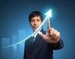 © Danaedet - Businessman touching glowing arrow rising, with bar chart in background
