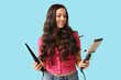 © Pixel-Shot - Beautiful young woman with different curling irons on blue background