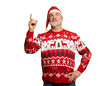 © opolja - Merry mature man wear knitted christmas sweater Santa hat presenting something on transparent background. New year shopping idea concept. New Year 2026 Christmas