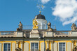 © Travel 'n' Lifestyle - View of ornate statues standing proudly atop a golden-trimmed koblenzer Tor building under a bright blue sky, Bonn, North Rhine-Westphalia, Germany.