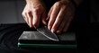 © Ievgen Skrypko - Male Hands Sharpening Kitchen Knife With Whetstone
