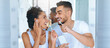 © Prostock-studio - A couple smiles at each other while brushing their teeth in a well-lit bathroom. They are enjoying their morning routine, showcasing joy and connection with playful gestures.