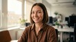 © Luz - Happy young businesswoman smiling confidently looking at camera in a modern bright office environment