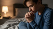 © DENIS - photo of teenage boy praying before bed.