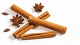 Cinnamon sticks and star anise arranged on a white background with spice pods.