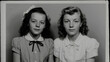 © Nikname - Two young girls posing for a black and white photograph