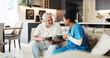 © SnapK/peopleimages.com - Coffee, healthcare or visit with nurse and old man on sofa in living room of home together. Caffeine, conversation or wellness with medical caregiver and senior patient drinking beverage in apartment