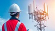 © admin_design - Professional telecommunications technician in hard hat inspecting tall cell tower crucial for modern wireless network functionality and robust connectivity.