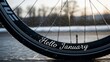 © data - Hello January text on bicycle wheel in rainy weather.