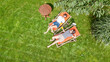 © Iuliia Sokolovska - Young girls relax in summer garden in sunbed deckchairs on grass, women friends have fun outdoors in green park on weekend, aerial drone view from above