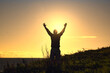 © Hq Visual Studio - Hiker raising arms at sunset overlooking Wild Atlantic Way Ireland coast adventure travel freedom outdoor lifestyle  nature scenic