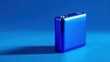 © Tanu - Compact blue device stands on solid blue surface with light creating shadow during daytime