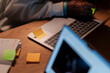 © Studio Marmellata - A person's hands are visible as they work on a laptop, with a sticky note reminding them of a meeting at 9:00 AM.