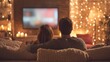 © backup_studio - A couple, man and woman, watching television at home on a cozy evening. Romantic date night or relaxing social media, TV streaming concept.