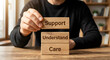 © Gambar - Human Hand Stacking Wooden Blocks with Support Understand Care Words in Warm Indoor Setting