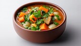 Delicious hearty vegetable beef soup with tender chunks of meat carrots potatoes herbs and fresh cilantro in a rustic brown bowl on a neutral background